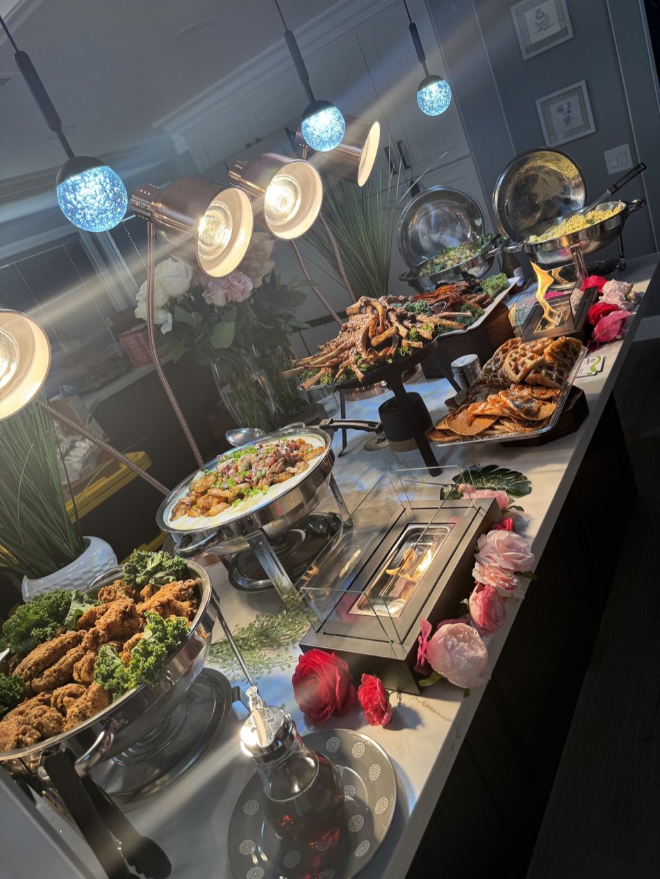 Styled brunch buffet under heat lamps with florals